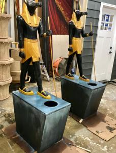 Anubis statues mounted to plinth bases which house LED RGB controlled lighting